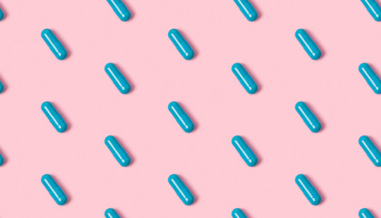 Seamless pattern with blue pills on a pink background.
