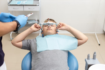 Doctor preparing his patient for fixing up orthodontic arch