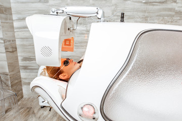 Woman in the spa capsule at the beauty salon