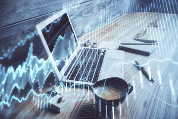 Double exposure of chart and financial info and work space with computer background. Concept of...