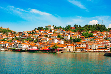 North macedonia. Ohrid. Different buildings and houses with red roofs on hill. View from lake
