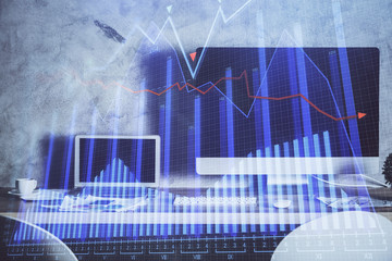 Double exposure of graph and financial info and work space with computer background. Concept of international online trading.