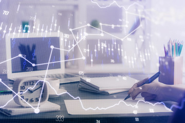 Financial graph displayed on woman's hand taking notes background. Concept of research. Multi exposure