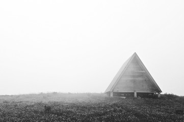 Wooden house in the fog