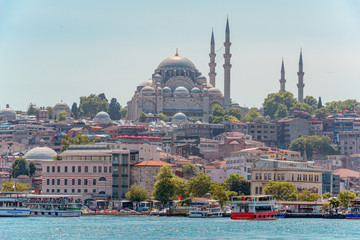 05/26/2019 Istanbul, Turkey, a standard and tourist look at The Blue Mosque also known as Sultan Ahmet. tourist image as a postcard. with boats and ferry on the Bosphorus Strait in the foreground