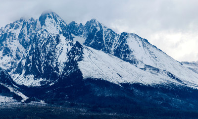 mountains and rocks covered with snow, overcast winter day, Tatras, Slovakia