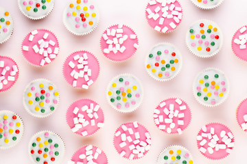 Colorful cupcakes on a white background.