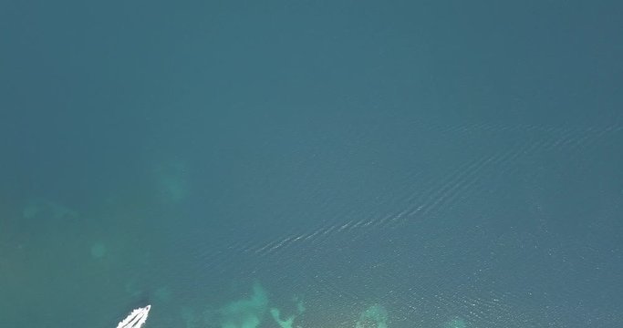 Halkidiki, Greece : boats and yachts moored near the private island  in a secluded location on the Aegean sea. View from drone
