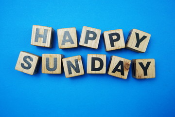 Obraz premium Happy Sunday alpahbet letter Top view on blue background
