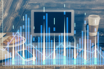 Double exposure of graph and financial info and work space with computer background. Concept of...