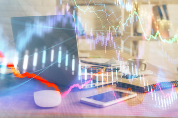Financial market graph hologram and personal computer on background. Double exposure. Concept of forex.