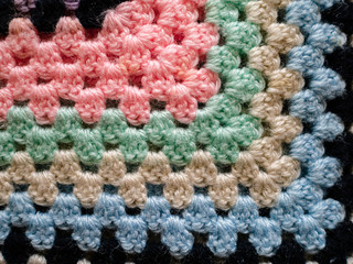 Fototapeta na wymiar Close up of bright crochet fabric blanket