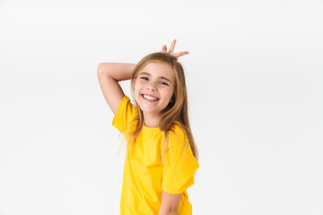 Portrait of cute blonde girl wearing casual t-shirt smiling and showing victory sign behind head as horns