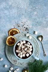 Obraz na płótnie Canvas Homemade festive hot chocolate with cinnamon and orange. Top view with copy space.