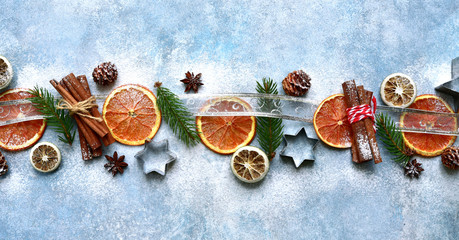 Festive christmas border made frome winter spices and candied fruits. Top view with copy space.
