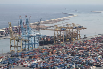 Editorial photography of  a Cargo being loaded in the harbor of Barcelona in Spain. Panorama picture with many containers and cranes. - 285022950