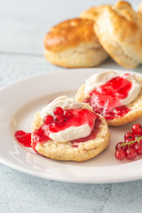 Obraz na płótnie Canvas Classic scones with cream and berry jam
