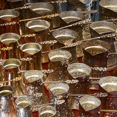 Fototapeta na wymiar Turkish coffee pots. Traditional copper and silver-plated coffee pot souvenirs from Bosnia. 
