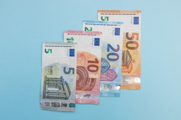 Euro currency cash bank notes money blue background