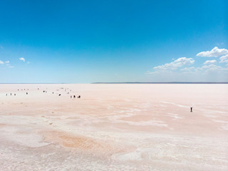 Aerial view of Lake Tuz, Tuz Golu. Salt Lake. White salt water. It is the second largest lake in Turkey. Central Anatolia. People standing in the middle of the salt lake