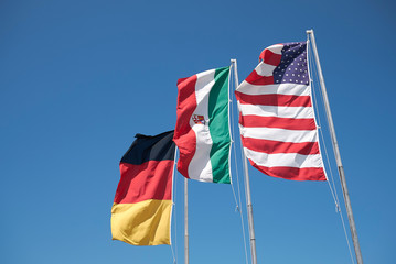 Milano Marittima, Italy -  July 29, 2019 : German, italian and american flag