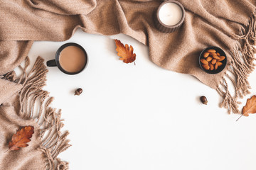 Autumn composition. Cup of coffee, plaid, autumn leaves on white background. Flat lay, top view, copy space