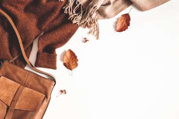Autumn composition. Sweater, plaid, autumn leaves on white background. Flat lay, top view, copy space