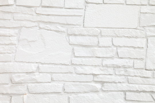 White sandstone wall with different size of stone for vintage monochrome background design purpose