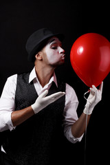 mime shows theatrical emotions on black background