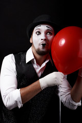 mime shows theatrical emotions on black background
