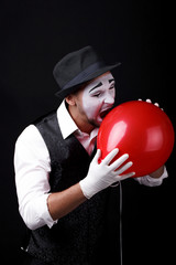 mime shows theatrical emotions on black background