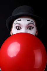 mime shows theatrical emotions on black background