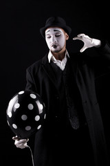 mime shows theatrical emotions on black background