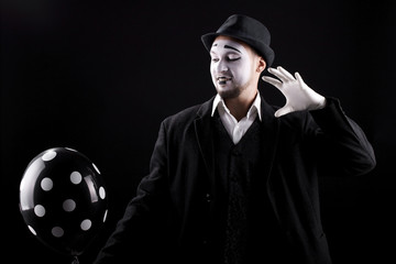 mime shows theatrical emotions on black background