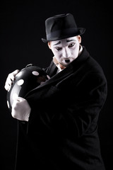 mime shows theatrical emotions on black background