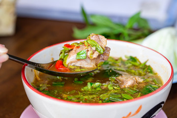 Hot Spicy and Sour Soup with Pork Ribs, ingredients with chili lemon young Tamarind leaves and basil