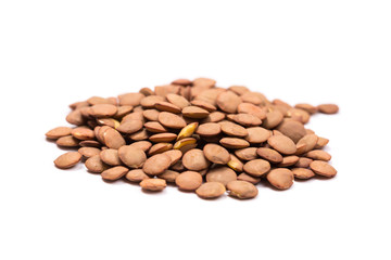 Isolated stack of uncooked lentils on white background from above.
