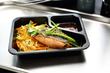 Grilled salmon fillet on pasta. Takeaway dish