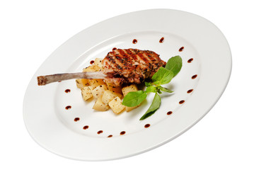 Fried rib of a young lamb with potato on white isolated background