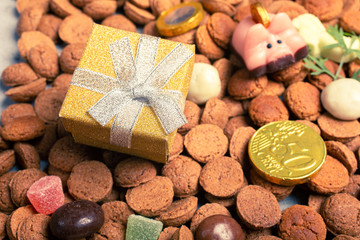 Beautiful St. Nicholas Day Greeting Card. Dutch holiday Sinterklaas background with gift and pepernoten. Children's party concept with copy space.