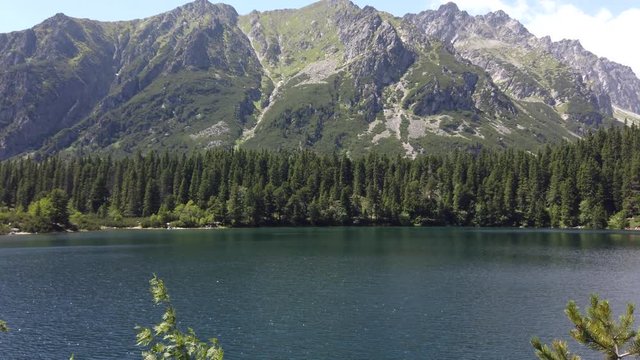 Popradské pleso lake surrounded by the tatra mountains.