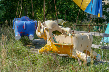 Fototapeta na wymiar Old abandoned elephant carousel. Sunny summer day. 