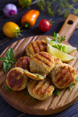 Fish cakes. Fish patties. Fried cutlets of minced fish on serving board