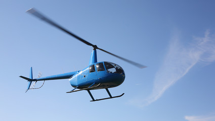 The aircraft - Blue small helicopter makes flight low  height