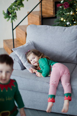 Cute children brother and sister elves, Santa's little helpers with a Christmas magic gifts
