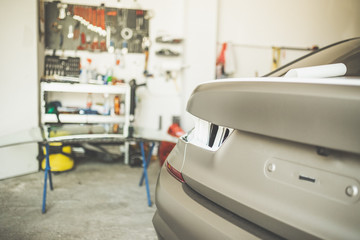 Car in garage prepared for repair.