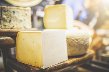 Close up of cheese slice on food fair street stand. Blank paper for copy.