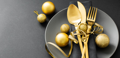 Gold cutlery served on plate for Christmas Dinner
