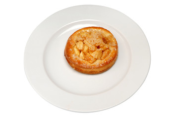 Buns with apples and cinnamon on plate on a white isolated background