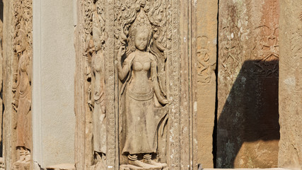 Bas reliefs depicting the beautiful Apsara deva on the wall at Angkor Wat Temple built in the 12th...